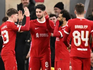 Liverpool's Hungarian midfielder #08 Dominik Szoboszlai celebrates scoring the team's fifth goal with Liverpool's English midfielder #53 James McConnell and Liverpool's Egyptian striker #11 Mohamed Salah during the UEFA Europa League round of 16 second leg football match between Liverpool and AC Sparta Praha at Anfield in Liverpool, north west England on March 14, 2024. (Photo by Oli SCARFF / AFP)