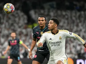 Real Madrid's English midfielder #5 Jude Bellingham vies with Manchester City's Swiss defender #25 Manuel Akanji during the UEFA Champions League quarter final first leg football match between Real Madrid CF and Manchester City at the Santiago Bernabeu stadium in Madrid on April 9, 2024. (Photo by JAVIER SORIANO / AFP)
