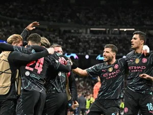 Manchester City's players celebrate English midfielder #47 Phil Foden second goal during the UEFA Champions League quarter final first leg football match between Real Madrid CF and Manchester City at the Santiago Bernabeu stadium in Madrid on April 9, 2024. (Photo by JAVIER SORIANO / AFP)