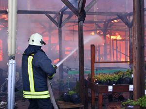 A Ukrainian firefighter intervenes to extinguish a fire at a hardware superstore following a Russian strike, in Kharkiv, on May 25, 2024, amid the Russian invasion of Ukraine. Kharkiv regional governor Oleg Synegubov said at least two people were killed when two Russian guided bombs hit a construction hypermarket. (Photo by SERGEY BOBOK / AFP)