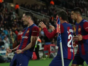Barcelona's Polish forward #09 Robert Lewandowski celebrates with teammates after scoring his team's third goal during the Spanish league football match between FC Barcelona and Valencia CF at the Estadi Olimpic Lluis Companys in Barcelona on April 29, 2024. (Photo by LLUIS GENE / AFP)