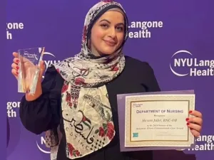 Hesen Jabr, a Palestinian American labor and delivery nurse, receiving an award in recognition for her compassion towards patients at NYU Longone Hospital (Instagram @iknowwhythejaybirdsings)