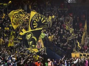 Dortmund fans celebrate their victory at the end of their UEFA Champions League semi-final second leg football match against Paris Saint-Germain (PSG) at the Parc des Princes stadium in Paris on May 7, 2024. (Photo by MIGUEL MEDINA / AFP)