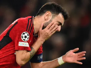 Manchester United's Portuguese midfielder #08 Bruno Fernandes reacts in pain during the UEFA Champions League group A football match between Manchester United and FC Bayern Munich at Old Trafford stadium in Manchester, north west England, on December 12, 2023. (Photo by PETER POWELL / AFP)