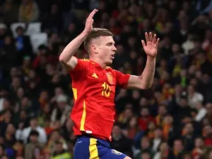 Spain's midfielder #10 Dani Olmo (up) celebrates scoring his team's second goal during the international friendly football match between Spain and Brazil at the Santiago Bernabeu stadium in Madrid, on March 26, 2024. Spain arranged a friendly against Brazil at the Santiago Bernabeu under the slogan "One Skin" to help combat racism. (Photo by Pierre-Philippe MARCOU / AFP)