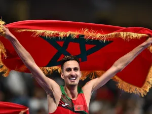 Morocco's Soufiane El Bakkali celebrates after winning the men's 3000m steeplechase final of the athletics event at the Paris 2024 Olympic Games at Stade de France in Saint-Denis, north of Paris, on August 7, 2024. (Photo by Jewel SAMAD / AFP)
