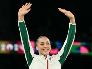 Gold medallist Algeria's Kaylia Nemour poses during the podium ceremony for the artistic gymnastics women's uneven bars event of the Paris 2024 Olympic Games at the Bercy Arena in Paris, on August 4, 2024. (Photo by Lionel BONAVENTURE / AFP)
