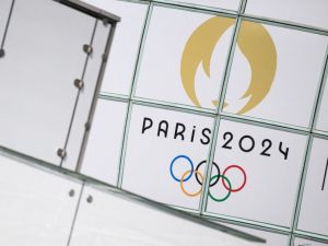 This photograph shows the logo of Paris 2024 Olympic games in front of skyscrapers at La Defense buisiness district on July 22, 2024, ahead of the Paris 2024 Olympic and Paralympic games. (Photo by Loic VENANCE / AFP)