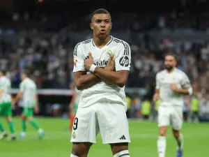 Real Madrid's French forward #09 Kylian Mbappe celebrates scoring his team's second goal from the penalty spot during the Spanish league football match between Real Real Madrid CF and Real Betis at the Santiago Bernabeu stadium in Madrid on September 1, 2024. (Photo by Thomas COEX / AFP)