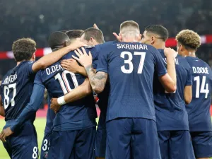 Paris Saint-Germain's players congratulate Paris Saint-Germain's Spanish midfielder #08 Fabian Ruiz after scoring PSG's second goal during the French L1 football match between Paris Saint-Germain (PSG) and Stade Brestois 29 (Brest) at The Parc des Princes Stadium, in Paris, on September 14, 2024. (Photo by GEOFFROY VAN DER HASSELT / AFP)