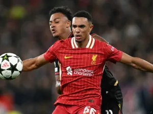 Bologna's Swiss forward #11 Dan Ndoye (R) vies with Liverpool's English defender #66 Trent Alexander-Arnold during the UEFA Champions League league stage football match between Liverpool and Bologna at Anfield in Liverpool, north west England on October 2, 2024. (Photo by Paul ELLIS / AFP)