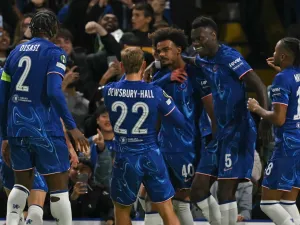 Chelsea's Portuguese midfielder #40 Renato Palma Veiga (C) celebrates with teammates after scoring the opening goal of the UEFA Conference League, league phase, football match between Chelsea and Gent at Stamford Bridge in London on October 3, 2024. (Photo by Glyn KIRK / AFP)