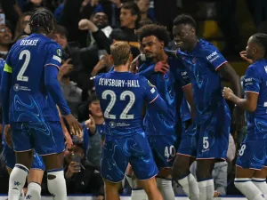 Chelsea's Portuguese midfielder #40 Renato Palma Veiga (C) celebrates with teammates after scoring the opening goal of the UEFA Conference League, league phase, football match between Chelsea and Gent at Stamford Bridge in London on October 3, 2024. (Photo by Glyn KIRK / AFP)