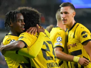 Borussia Dortmund's English forward #43 Jamie Bynoe-Gittens (L) celebrates with teammates after scoring his team's second goal during the UEFA Champions League's 1st round day 1 football match between Club Brugge KV and Borussia Dortmund at the Jan Breydel Stadium in Bruges on September 18, 2024. (Photo by NICOLAS TUCAT / AFP)