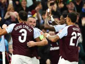 Aston Villa's Scottish midfielder #07 John McGinn (2nd L) celebrates with teammates after scoring his team first goal during the UEFA Champions League football match between Aston Villa and Bologna at Villa Park in Birmingham, central England on October 22, 2024. (Photo by Darren Staples / AFP)