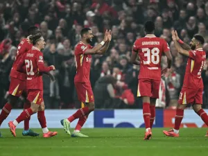 Liverpool's Dutch striker #18 Cody Gakpo (C) celebrates after scoring his team second goal during the UEFA Champions League football match between Liverpool and Bayer Leverkusen at Anfield stadium, in Liverpool, north west England, on November 5, 2024. (Photo by Paul ELLIS / AFP)