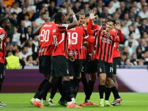 AC Milan's Dutch midfielder #14 Tijani Reijnders (R) celebrates scoring their third goal during the UEFA Champions League, league phase day 4 football match between Real Madrid CF and AC Milan at the Santiago Bernabeu stadium in Madrid on November 5, 2024. (Photo by OSCAR DEL POZO / AFP)