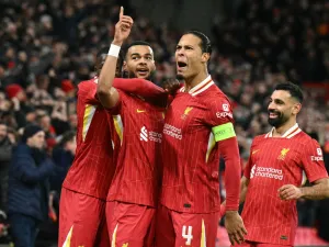 Liverpool's Dutch striker #18 Cody Gakpo (2L) celebrates scoring the team's second goal with Liverpool's Dutch defender #04 Virgil van Dijk during the UEFA Champions League football match between Liverpool and Real Madrid at Anfield in Liverpool, north west England on November 27, 2024. (Photo by Oli SCARFF / AFP)