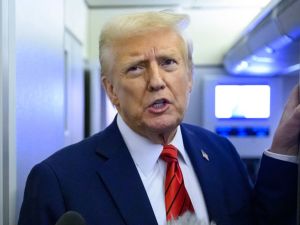 US President Donald Trump speaks to reporters while in flight on Air Force One en route Joint Base Andrews in Maryland on January 27, 2025. (Photo by Mandel NGAN / AFP)