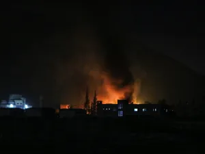 Syrians check the damage after Israeli troops