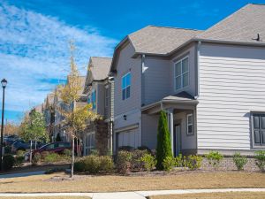 Corner two story houses by large residential street