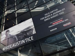 A banner calling for the release of Austin Tice, the only American journalist held captive in Syria, is displayed at the Newseum in Washington, DC on November 2, 2016. (Photo by ANDREW CABALLERO-REYNOLDS / AFP)
