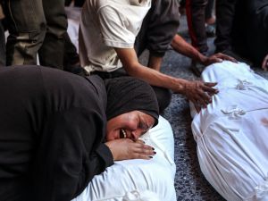 Israeli strikes hit café, charging station in Gaza, killing dozens of civilians