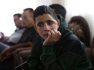 Palestinian Mohammed al-Tamimi, 15, sits at his family home in the West Bank city of Ramallah on Feb. 27, 2018. Mohammed, who is the cousin of jailed teenager Palestinian activist Ahed Tamimi, was shot in the head with a rubber bullet in December leaving him with permanent damage to his skull, relatives say. 
(ABBAS MOMANI / AFP)