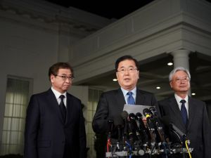South Korean National Security Advisor Chung Eui-yong (C), flanked by South Korea National Intelligence Service chief Suh Hoon (L) and South Korea's ambassador to the United States Cho Yoon-je (R), briefs reporters outside the West Wing of the White House on Mar. 8, 2018 in Washington, DC, announcing North Korean leader Kim Jong Un has offered to meet U.S. President Donald Trump. 
(MANDEL NGAN / AFP)
