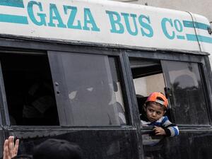 A boy looks out from a window as he rides on a bus waiting in Khan Yunis to cross into Egypt from the Rafah border crossing in the southern Gaza Strip on April 28, 2018, after it was opened for three days to allow humanitarian cases to pass. 
(SAID KHATIB / AFP)