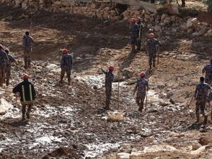 Jordanian rescue teams search for missing persons following flash floods in the city of Madaba near the capital Amman on November 10, 2018. ()