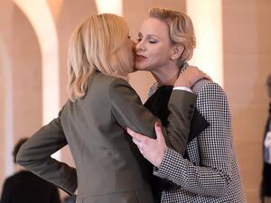 French President's wife Brigitte Macron (L) welcomes Princess Charlene of Monaco as they take part in a spousal event at the Chateau de Versailles. (Lucas BARIOULET / AFP)