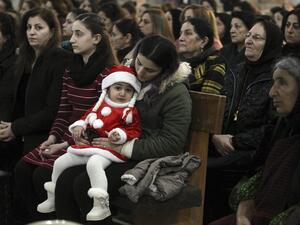 Iraqi Christians attend mass on Christmas eve at the Grand Immaculate Church in the predominantly Christian Iraqi town of Qaraqosh. (AFP)