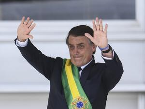 Brazil's new President Jair Bolsonaro waves to the crowd after receiving the presidential sash during his inauguration ceremony, at Planalto Palace in Brasilia on January 1, 2019. (AFP/File)
