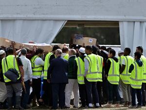 Mourners carry the coffins of Khalid Mustafa and his son Hamza Mustafa, slain by an Australian white supremacist gunman who shot down 50 Muslims at two mosques, during a funeral at the Memorial Park cemetery in Christchurch on March 20, 2019. (AFP/ File)