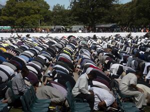 Muslims offer Friday prayer led by Gamal Fouda, imam (lead cleric) of tragedy-stricken Al Noor mosque, during a gathering for prayers and to observe a two minutes of silence for victims of the twin mosques massacres at Hagley Park in Christchurch  (AFP)
