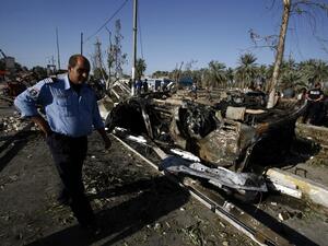 Iraqi emergency responders inspect debris at the site of a truck bomb, that exploded at a crowded checkpoint, in the Iraqi city of Hilla, south of Baghdad on March 6, 2016. (AFP/Haidar Hamdani)
