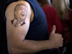A tattoo of US Republican presidential hopeful Donald Trump is seen on the arm of Anthony Borbell during a rally March 14, 2016 in Vienna Center, Ohio. (AFP/File)
