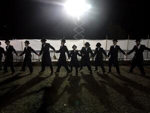 Ultra-Orthodox Jewish Hasidim dance during the wedding ceremony of Parowol Mirel Lamber, the bride from the Toldos Avrohom Yitzchok Hasidim community, and Natan Meir Neta Hilbershtam, the groom from the Tzanz Hasidic dynasty, on March 15, 2016, in the Israeli central city of Netanya. (AFP/Menahem Kahana)
