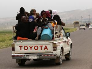 Iraqi families fleeing the violence in the northern city of Mosul arrive at the Kurdish checkpoint of Makhmur, about 280 kilometers (175 miles) north of the capital Baghdad, on March 26, 2016. (AFP/Safin Hamed)