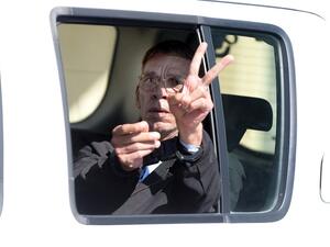 Seif al-Din Mohamed Mostafa, an Egyptian man who hijacked an EgyptAir passenger plane the previous day and forced it to divert to Cyprus demanding to see his ex-wife, flashes the "V" for victory sign as he leaves the court in Larnaca in a police car on March 30, 2016. (AFP/George Michael)
