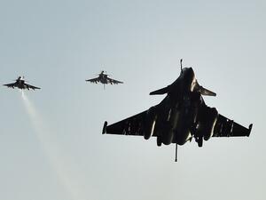 French Rafale fighter jets return to the Charles-de-Gaulle aircraft carrier on November 23, 2015 after conducting airstrikes in Iraq and Syria. (AFP/Anne-Christine Poujoulat)