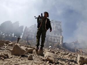 Houthi rebel fighters inspect the damage after a reported air strike carried out by the Saudi-led coalition targeted the presidential palace in the Yemeni capital Sanaa on Dec. 5, 2017. (Mohammed HUWAIS / AFP)