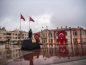 A municipality worker walks in front of a government building in the Turkish border province of Kilis on January 24, 2018. Rockets fired from Syria killed two people and wounded 11 others on January 24 in southern Turkey on the fifth day of Ankara's offensive against a Syrian Kurdish militia which President Recep Tayyip Erdogan vowed to eliminate.
(OZAN KOSE / AFP)
