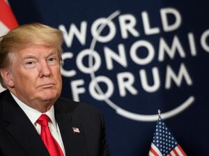 U.S. President Donald Trump looks on as he sits next to the logo of the World Economic Forum (WEF) annual meeting on January 26, 2018 in Davos, eastern Switzerland. 
(Fabrice COFFRINI / AFP)