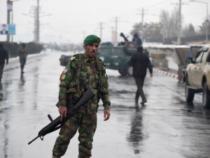 Afghan security personnel stand guard near the site of an attack near the Marshal Fahim Military Academy base in Kabul on Jan. 29, 2018 (WAKIL KOHSAR / AFP)