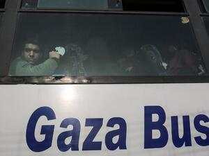 A Palestinian looks out of the window of a bus as travelers arrive at the Rafah border crossing in the southern Gaza Strip to cross into Egypt, after it was opened by Egyptian authorities for humanitarian cases on Feb. 7, 2018.
(SAID KHATIB / AFP)