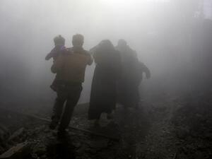 A Syrian family walks through a dust cloud while fleeing from reported regime air strikes in the rebel-held town of Jisreen, in the besieged Eastern Ghouta region on the outskirts of the capital Damascus, on Feb. 8, 2018. A fourth consecutive day of heavy regime bombing raids on the rebel-held enclave of Eastern Ghouta near Damascus killed 22 civilians on Feb. 8, a monitor said.
(ABDULMONAM EASSA / AFP)