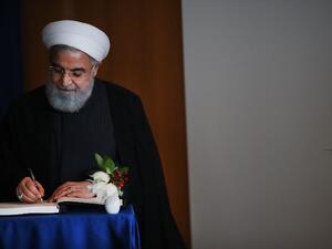 Iranian President Hassan Rouhani signs a book as he attends a meeting with Antonio Guterres, the Secretary-General of the United Nations, during the 73rd United Nations (U.N.) General Assembly on September 26, 2018 in New York City (AFP)