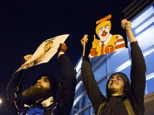 Protesters celebrate outside of the University of Illinois at Chicago Pavilion where Republican presidential candidate Donald Trump cancelled a campaign rally over safety concerns March 11, 2016 in Chicago, Illinois. (AFP/Jonathan Gibby)